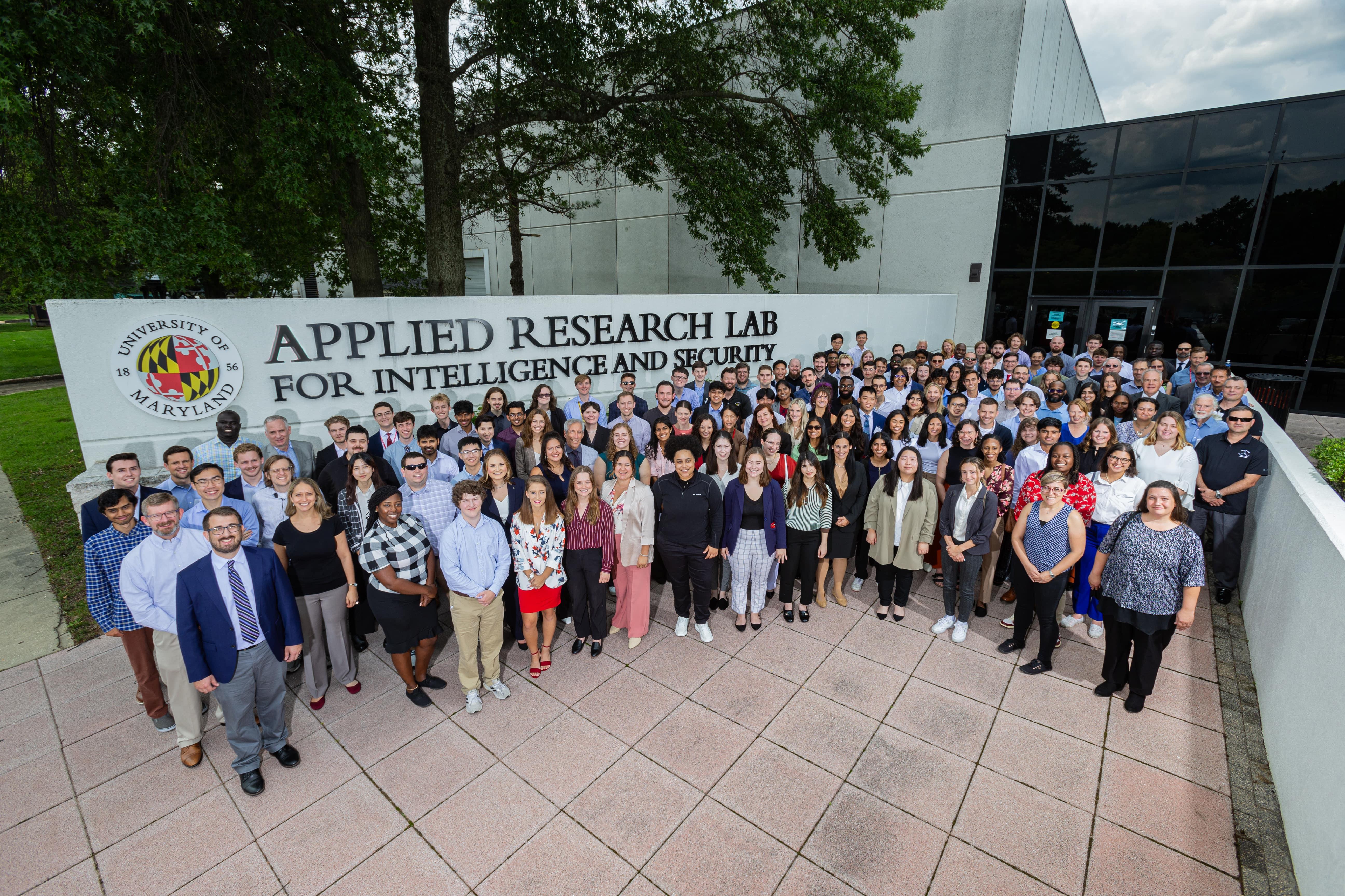 arlis members in front of the sign